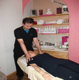 Japanese lady having Shiatsu massage over the clothing. Special Cardiff Shiatsu treatment clinic