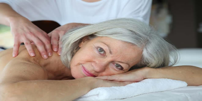 old female with back pain having sports massage at our cardiff clinic